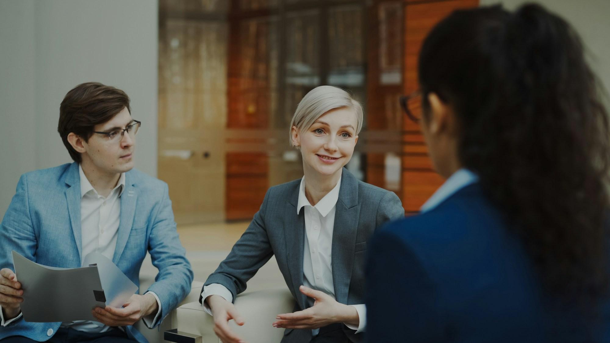 Business professionals discussing documents during an expert conversation