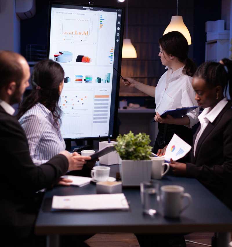 Research professionals collaborating around a screen