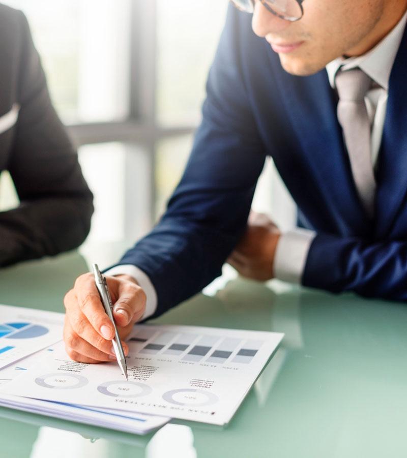 A business specialist reviewing a printed report